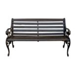 A two seater garden bench, of typical cast metal and wooden slat form, the arms with lion mask