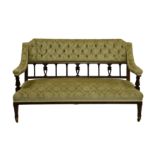 A late Victorian mahogany settee, with buttoned, floral, green velour top rail over classical column