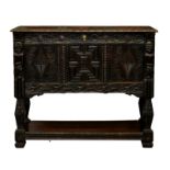 A Victorian heavily carved oak buffet cabinet, using earlier elements, the three panel top over a