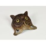 An antique novelty German cast metal table or wall bell fashioned as an owl's face, with realistic