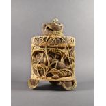 A fine Japanese carved ivory lidded box, 19th century, carved in bas relief around the sides with