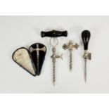 A collection of champagne taps and trocar spikes, including one cased, opening to reveal silk
