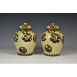 A pair of Japanese polychrome glazed earthenware covered vases, 1920s-30s, ovoid form with domed
