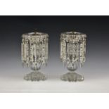 A pair of Victorian clear cut glass table lustres, the printie cut scalloped pans suspending