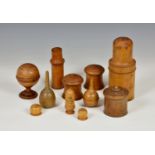 Treen - a group of turned boxwood containers, comprising a 19th century cylindrical container