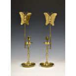A pair of Korean brass butterfly candlesticks, first half 20th century, the foliate chased dished