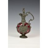 A Dutch style pewter and cranberry glass flagon, late 19th century in the early 18th century