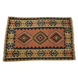 A Kilim rug with all over geometric design and three medallions, in pale salmon pink, ivory and