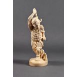 A Japanese carved ivory okimono of a shellfish digger, Meiji period (1868-1912), holding a three