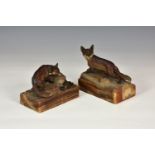 Two antique cold painted bronze figures of foxes, each on naturalistic stone ground, raised on