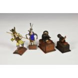 Two Japanese boxwood Kobe toy automatons, one playing an instrument, the other eating, one with