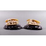 A pair of French carved ivory figures, 19th century, each lying in a half open mussel shell, one