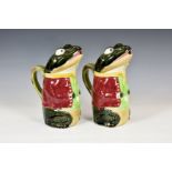 A pair of Majolica water jugs of possible 'Beatrix Potter' or 'Kenneth Grahame' interest, with