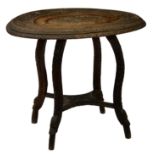 An Anglo-Indian carved hardwood oval occasional table, early 20th century, the top carved with a