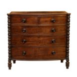 A Regency mahogany bowfront chest of drawers, the reeded top over bobbin turned pilaster flanking