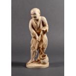 A Japanese carved ivory okimono of a spear fisherman, Meiji period (1868-1912), holding a trident