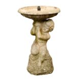 A composite stone putto water feature, 15in. (38.1cm.) diameter, 24½in. (62.2cm.) high.