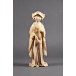 A Japanese carved ivory okimono, Meiji period (1868-1912), the finely carved female figure in
