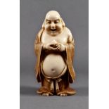 A Japanese carved ivory okimono of Hotei holding a peach, Meiji period (1868-1912), standing in