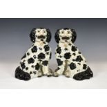 A pair of large black and white Staffordshire Spaniels, 19th century, of typical form with