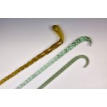 Three Victorian glass walking canes, one long example in tapered barleytwist pale blue glass, 53½in.