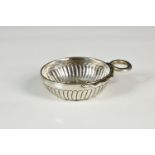 An early 20th century French silver tastevin, with dimpled and gadrooned decoration with coiled