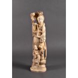 A Japanese carved ivory okimono of a mother and child, Meiji period (1869-1912), standing with one