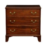 A George III mahogany chest of drawers, of small proportions, the moulded top over three graduated