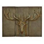 A triptych artwork of a stag's head, the resin panels finished to imitate stone, 42 x 31½in. (106.75