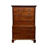 A George III mahogany chest on chest, the flared top with dentil carved cornice over two short and