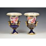 A closely matched pair of Coalport twin handled campagna style urns, c.1820, painted with panels