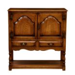 A 20th century mid oak side cabinet by Archer & Smith of Swindon, of small, court cupboard form, the