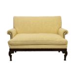 A late Victorian carved mahogany George II style sofa, in pale gold damask with studded scroll