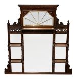 An Edwardian walnut overmantel mirror, with dentil and foliate carved decoration, pierced scrollwork