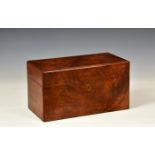 A Victorian walnut tea caddy, rectangular with chamfered edges, two arched canisters flanking a