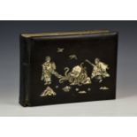 A Japanese lacquer photograph album, early 20th century, the cover with mother of pearl and carved