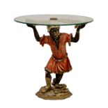 An Italian blackamoor drinks table, 20th century, the painted figure supporting a circular glass