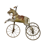 A late 19th or early 20th century child's carved and gesso painted horse velocipede tricycle, dapple