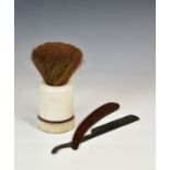 A novelty vintage advertising counter top over sized bakelite shaving brush and cut throat razor,