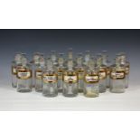 A set of sixteen matched 19th century clear glass Apothecary bottles, with various necks and rims,