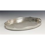 A silver plated copper oval drinks tray, the pierced, wavy rim with gadrooned border and cut-out