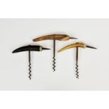 Three direct pull horn and spike corkscrews, the largest 6in. (15.2cm.) wide including spike. (3)