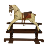 A late 19th to early 20th century gesso painted and carved wooden rocking horse, in unrestored