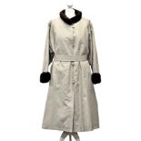 An elegant mink lined raincoat by Christian of Bond Street, the cotton gabardine coat with four