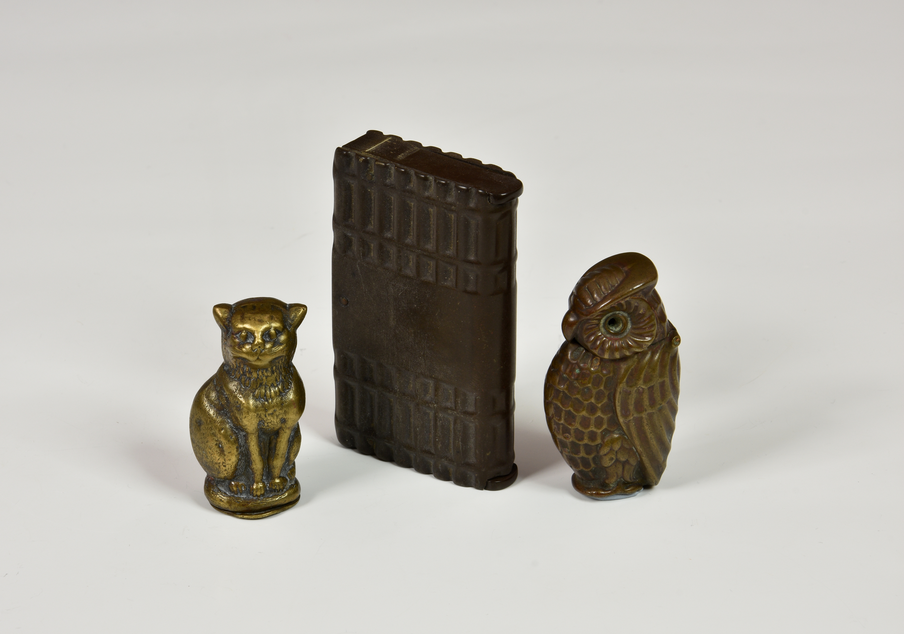 Two Edwardian novelty brass vesta cases, the first modelled as a seated cat, hinged cover beneath