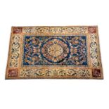 An Aubusson style rug with foliate medalion on a cream ground, the blue ground field with