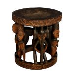 An African carved and stained hardwood tribal table, probably early 20th century, the slightly