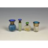 Four silver and enamel mounted cut glass scent bottles, with guilloche enamel decoration to the