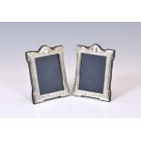 A pair of small Victorian style silver easel back photo frames, John Bull Ltd., Sheffield 1990,
