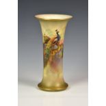 A Royal Worcester porcelain trumpet vase, painted with a pair of peacocks on a fir branch in a misty